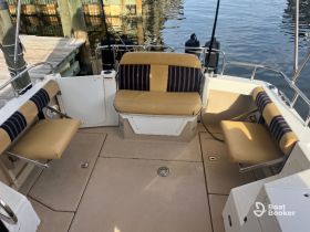 Interior view of a boat's seating area, featuring comfortable cushions and a clean layout, perfect for relaxing while on the water.