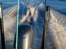 A dynamic view of a speedboat in motion, leaving a wake on the water — perfect for showcasing thrilling boating experiences.