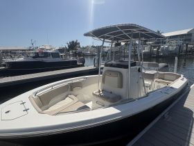 A sleek center console boat docked at the marina, showcasing its spacious seating and modern design — perfect for a day on the water.