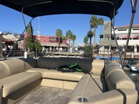 Interior view of a spacious seating area on a pontoon boat, perfect for relaxing and enjoying the waterfront scenery.