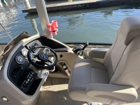A well-equipped helm area featuring a comfortable captain's chair and control console, perfect for navigating the waters.