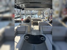 Interior view of a spacious boat cabin featuring comfortable seating and a helm, perfect for relaxing and enjoying time on the water.