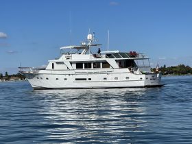 A stunning side view of a luxurious yacht, showcasing its elegant design while docked in calm waters, perfect for upscale boating experiences.