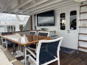 Interior view of a spacious dining area on a yacht, featuring a polished table and comfortable seating — perfect for enjoying meals while cruising.