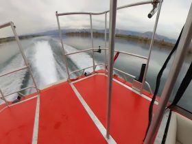 A dynamic view from the back of a speedboat, showcasing the powerful wake as it glides across calm waters, perfect for thrilling water adventures.
