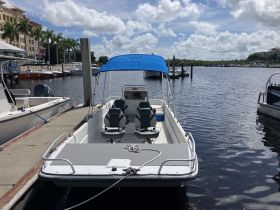 A speedboat docked at a marina, showcasing its sleek design and comfortable seating, perfect for a day on the water.