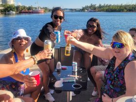 A lively group of friends toasting with drinks aboard a pontoon boat, capturing the essence of a fun-filled day on the water.