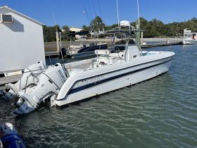 A sleek Glacier Bay speedboat docked at the marina, showcasing its modern design and powerful twin engines — perfect for fishing or leisure outings.