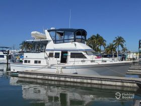 A beautiful yacht docked at the marina, showcasing its elegant design and spacious layout, perfect for luxury boating experiences.