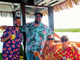 A cheerful group enjoys drinks and camaraderie aboard a boat, perfect for celebrating special moments on the water.