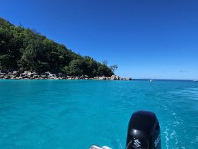 A stunning view of turquoise waters and a lush coastline, perfect for exploring the beauty of nature while boating.
