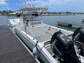 A detailed view of the helm and console area of a boat, showcasing its modern design and features, ideal for fishing or cruising.