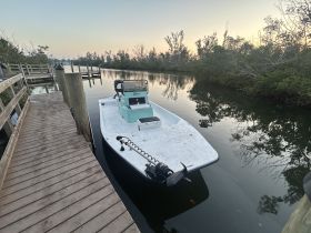A serene view of a boat docked along a calm waterway, surrounded by lush greenery — perfect for exploring the tranquil beauty of nature.
