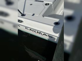 Close-up view of a Caymas boat docked, showcasing its sleek design and hull details — perfect for fishing or leisure outings.