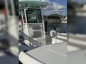A detailed view of the helm and seating area inside a Caymas boat, showcasing modern design and comfort for an enjoyable boating experience.
