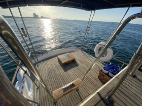 A serene view of the boat's interior, showcasing the wooden deck and seating area, perfect for relaxation while enjoying the open water.