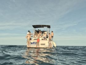 A lively group of friends enjoys a day on the water, relaxing and having fun aboard a boat in Cancun — perfect for summer adventures and unforgettable memories.