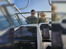 A couple enjoys a scenic boat ride, capturing the essence of adventure on the water. Perfect for romantic getaways or leisurely outings.