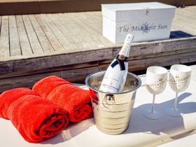 A stylish setup featuring Moët & Chandon champagne, elegant glasses, and plush towels, perfect for a luxurious day on the water.