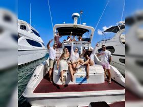 A lively group celebrates aboard a yacht, enjoying the sun and each other's company — perfect for memorable outings and parties on the water.