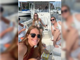 A fun group of friends enjoying drinks on a boat, capturing the perfect moment for a memorable day on the water.