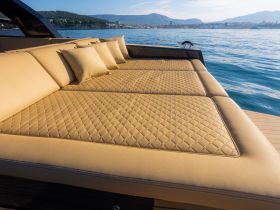 Luxurious lounge seating on a boat, featuring plush cushions and a stunning view of the water, perfect for relaxation and enjoying the sun.