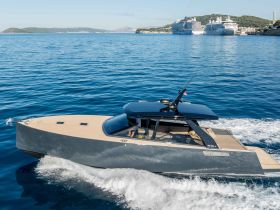 A sleek speedboat glides through clear waters, showcasing its modern design and elegance, perfect for luxury outings on the sea.