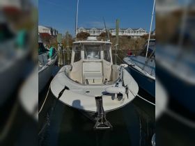 A clear view of a center console boat docked at the marina, showcasing its sleek design and features.