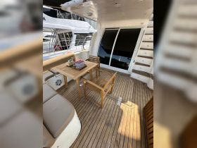 A cozy dining area inside a boat featuring a wooden table and chairs, perfect for enjoying meals while cruising.