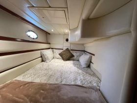 Cozy cabin interior featuring a comfortable sleeping area with plush pillows, perfect for relaxation on a boat getaway.