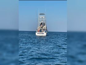 A lively group aboard the fishing boat 'Havoc' enjoys a day on the water, perfect for fishing adventures and group outings.
