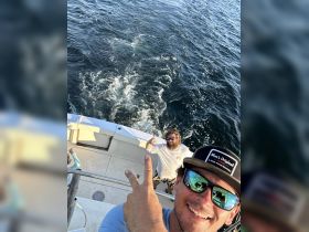 Two friends enjoy a fun moment aboard a boat, capturing the excitement of their trip with a selfie — perfect for memorable adventures on the water.