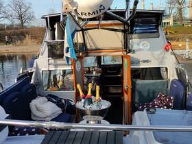 A cozy interior view of a boat featuring comfortable seating and a well-stocked bar with champagne on ice, perfect for a relaxing day on the water.