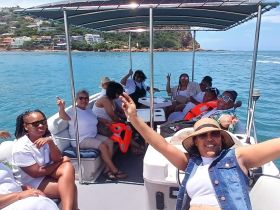 A lively group enjoys a fun day on the water, celebrating together aboard a boat — perfect for gatherings and memorable experiences.