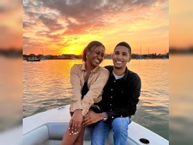 A joyful couple enjoys a romantic sunset on a boat, capturing the perfect moment for a memorable evening on the water.