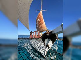 A stunning view of a sailboat in motion, showcasing its elegant sails against a clear blue sky — perfect for sailing enthusiasts and adventure seekers.