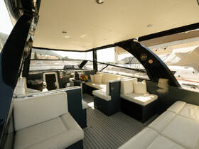 Interior view of a stylish boat cabin featuring comfortable seating and a well-equipped helm, perfect for relaxing while cruising.