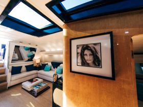 A stylish interior view of a yacht's lounge area featuring comfortable seating and elegant decor, perfect for relaxing on the water.