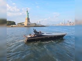 A stylish boat cruises past the iconic Statue of Liberty, with guests enjoying the scenic views of New York City — a perfect backdrop for memorable outings.