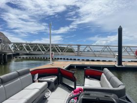A view of the comfortable seating area inside a pontoon boat, showcasing a relaxing space perfect for enjoying time on the water.