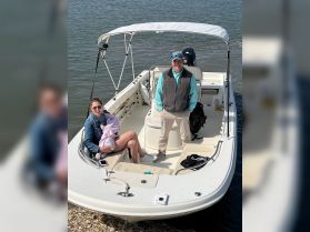 A family enjoys a sunny day on a boat, creating lasting memories together on the water.