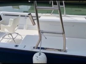 Interior view of a boat's helm area featuring modern seating and a clean layout, ideal for comfortable navigation.