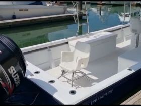Interior view of a boat showcasing a clean and spacious seating area, ideal for fishing or leisurely outings on the water.