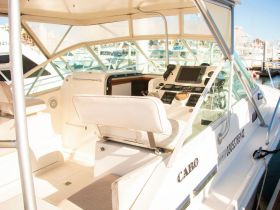 A bright and spacious helm area of a boat, showcasing the console and seating, perfect for navigating the waters in comfort.