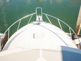 Aerial view of the bow of a boat docked in calm waters, showcasing the sleek design and structure, perfect for marine enthusiasts.