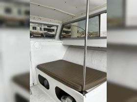 Interior view of a boat cabin featuring a comfortable seating area, ideal for relaxing while on the water.