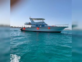 The 'Queen of Life' yacht glides through crystal-clear waters, showcasing its elegant design and perfect for luxurious outings on the sea.