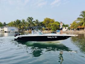 A speedboat named 'Coming In Hot' navigates through calm waters, showcasing a fun day of fishing with friends. Perfect for adventure seekers looking to enjoy the great outdoors.