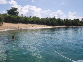 A serene beach scene featuring a group enjoying the water, perfect for relaxation and fun in the sun.