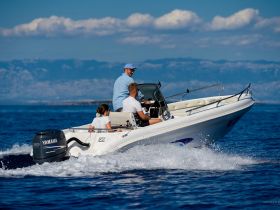 A family enjoys a thrilling ride on a speedboat, showcasing the excitement of on-water adventures in beautiful surroundings.